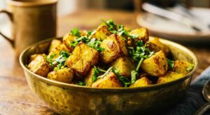 Crispy air fryer aloo fry topped with fresh cilantro served in a bowl